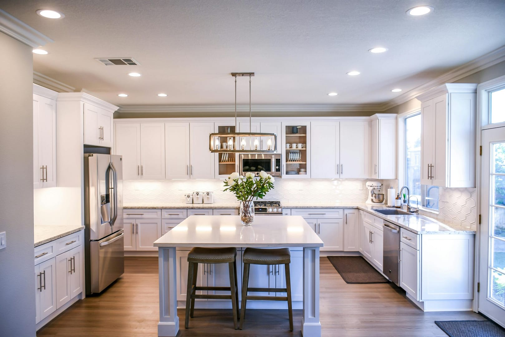 kitchen remodel with white cabinetry, island, and stainless steel appliances.